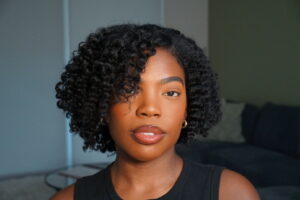 Krissy Lewis wearing a defined, side-part twist-out on blown-out natural hair.