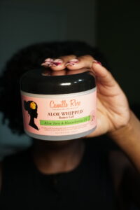 Camille Rose Aloe Whipped Butter Gel held for natural hair.